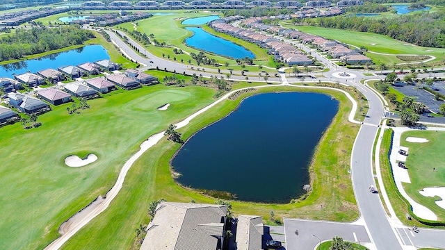 aerial view featuring a residential view, golf course view, and a water view