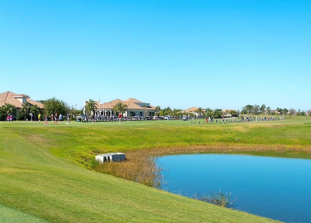 view of home's community with a lawn and a water view