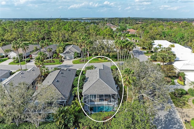 birds eye view of property with a residential view and a view of trees