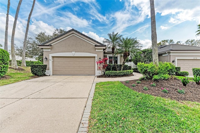 single story home with driveway, a tiled roof, an attached garage, and stucco siding