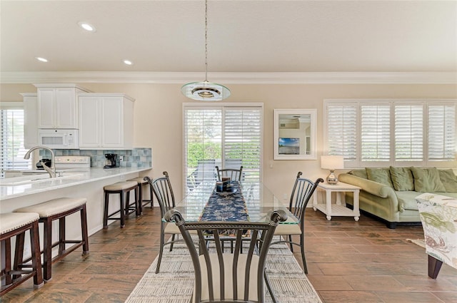 dining room featuring crown molding and recessed lighting