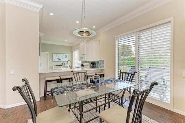 dining area with ornamental molding, visible vents, dark wood finished floors, and baseboards