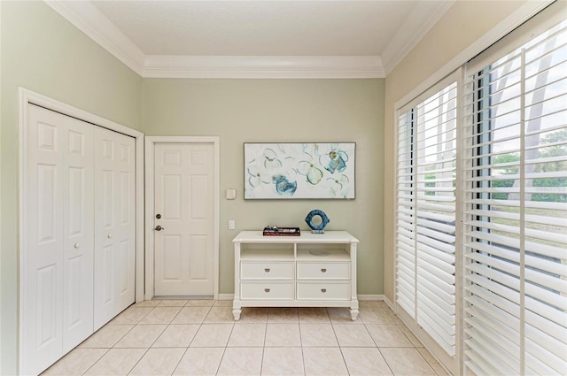 unfurnished bedroom with light tile patterned floors, baseboards, and crown molding