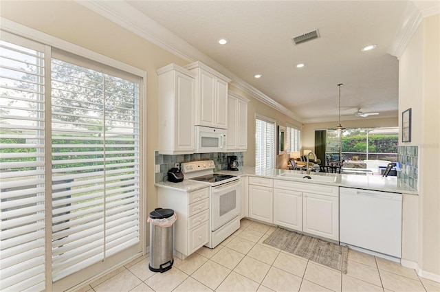 kitchen featuring white appliances, tasteful backsplash, visible vents, crown molding, and light tile patterned flooring