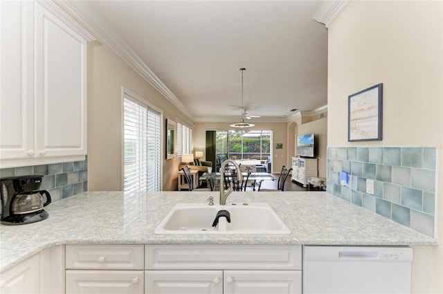 kitchen with decorative backsplash, ornamental molding, open floor plan, a sink, and dishwasher