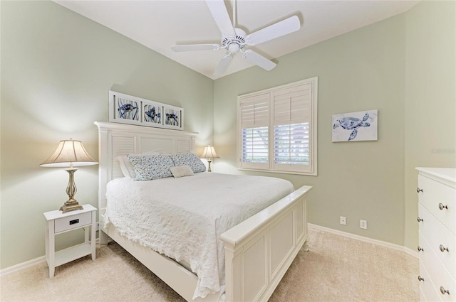 bedroom with a ceiling fan, light carpet, and baseboards