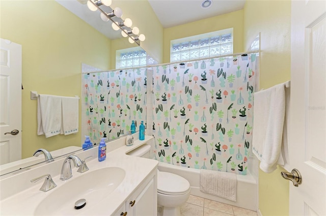 full bath featuring toilet, vanity, tile patterned flooring, and shower / bath combo with shower curtain