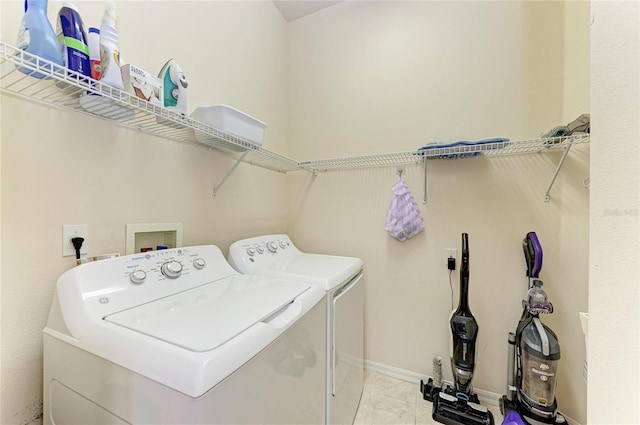 washroom featuring laundry area, tile patterned flooring, and washer and clothes dryer