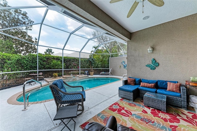 view of pool with a pool with connected hot tub, an outdoor hangout area, a ceiling fan, a patio area, and a lanai