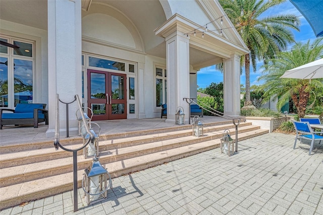 entrance to property featuring french doors and stucco siding