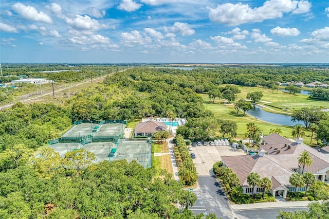 bird's eye view with a water view, view of golf course, and a view of trees