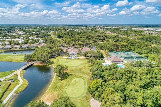 drone / aerial view featuring golf course view and a water view