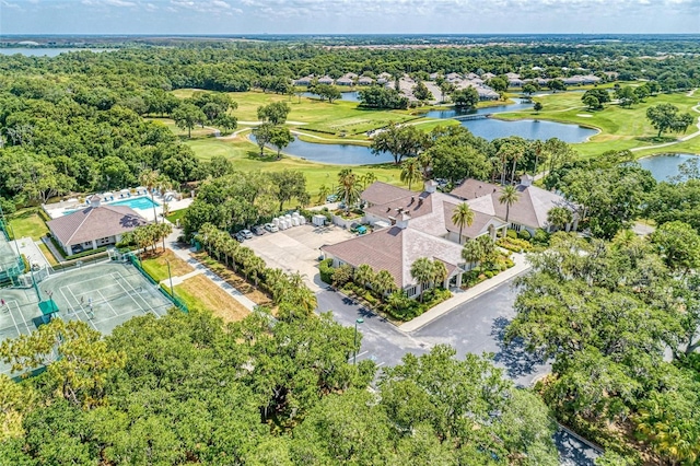 drone / aerial view with view of golf course and a water view