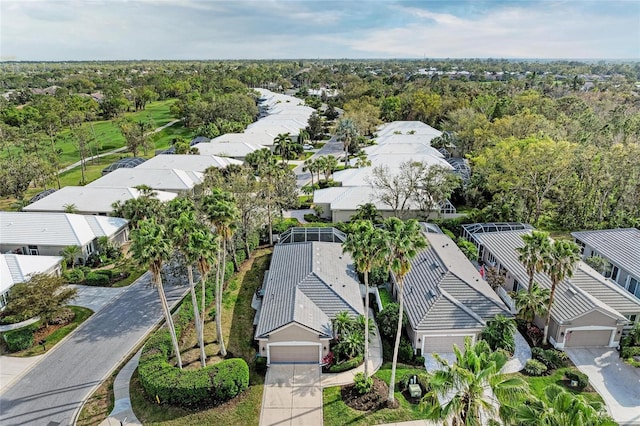 drone / aerial view with a forest view and a residential view