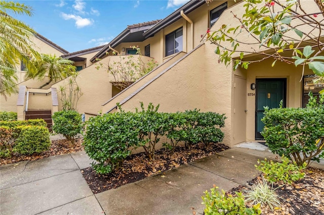 doorway to property featuring stucco siding