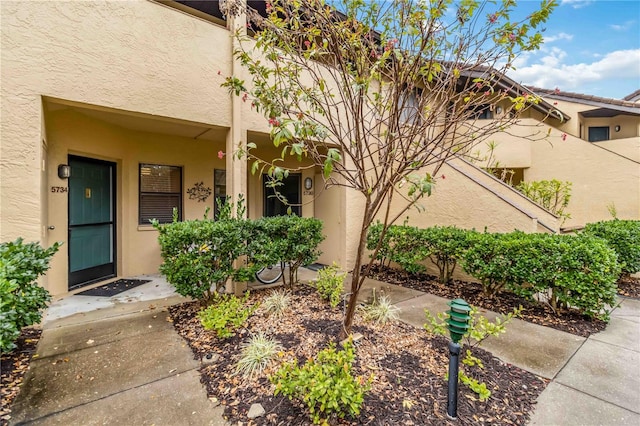 doorway to property with stucco siding