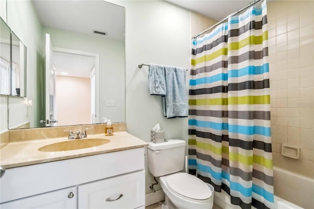 bathroom featuring toilet, visible vents, shower / bath combo with shower curtain, and vanity