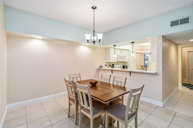 dining area with an inviting chandelier, visible vents, baseboards, and light tile patterned floors