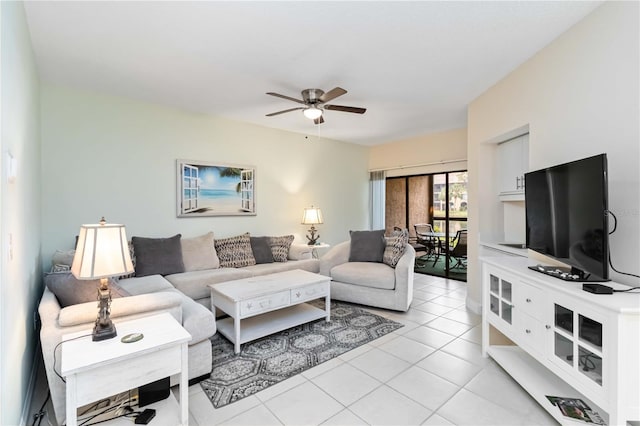 living area with light tile patterned floors and a ceiling fan