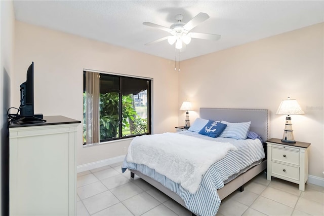 bedroom with ceiling fan, light tile patterned flooring, and baseboards