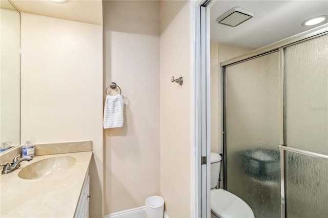 bathroom with vanity, toilet, and an enclosed shower