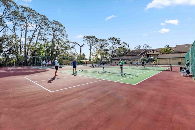 view of tennis court featuring fence