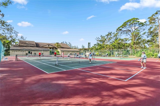 view of sport court featuring fence