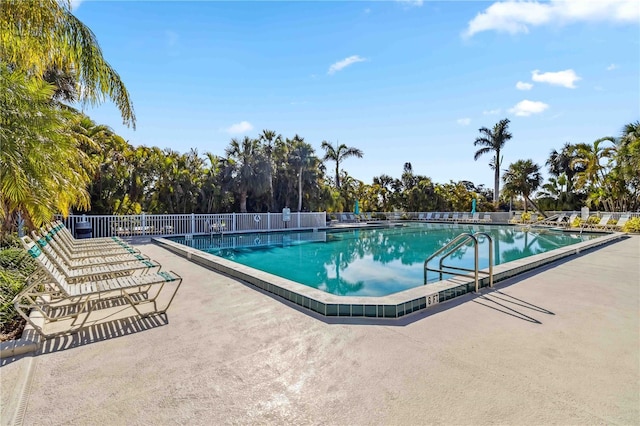 pool featuring fence and a patio