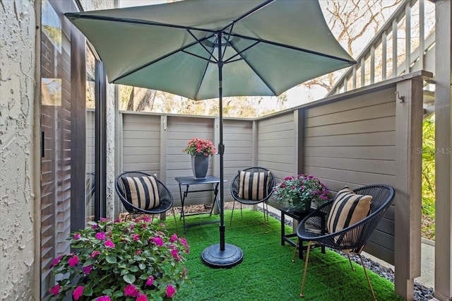 view of patio featuring fence