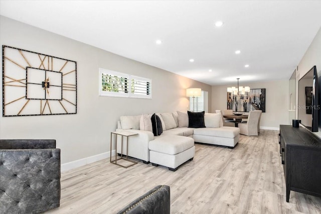 living room featuring baseboards, wood finished floors, and recessed lighting