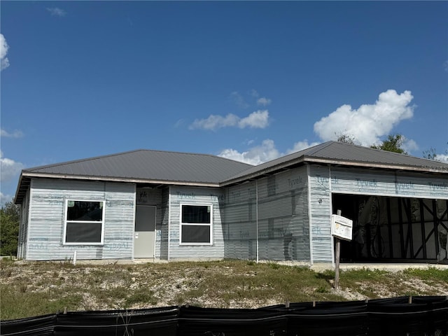 view of front facade with metal roof and an attached garage