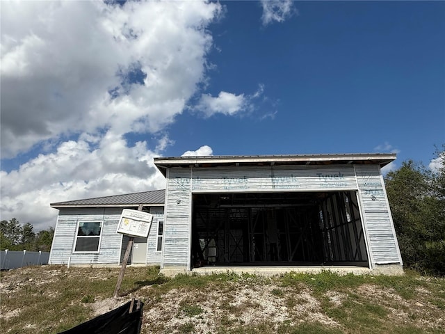 property under construction with a garage and metal roof