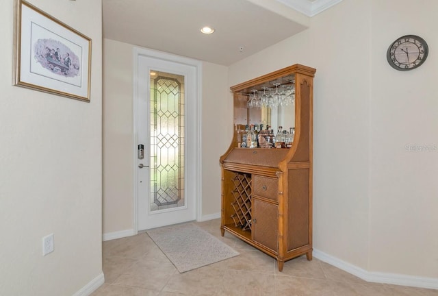 foyer with recessed lighting, baseboards, and light tile patterned floors