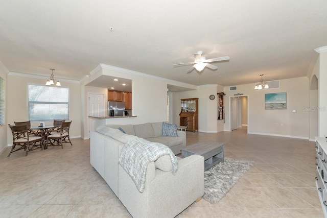 living room with light tile patterned floors, baseboards, arched walkways, and crown molding