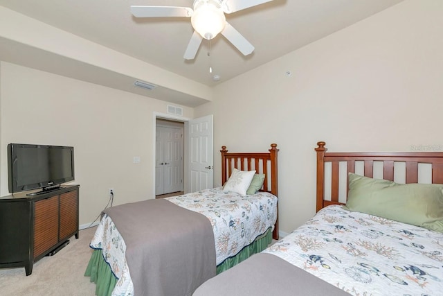 bedroom with ceiling fan, visible vents, and light colored carpet