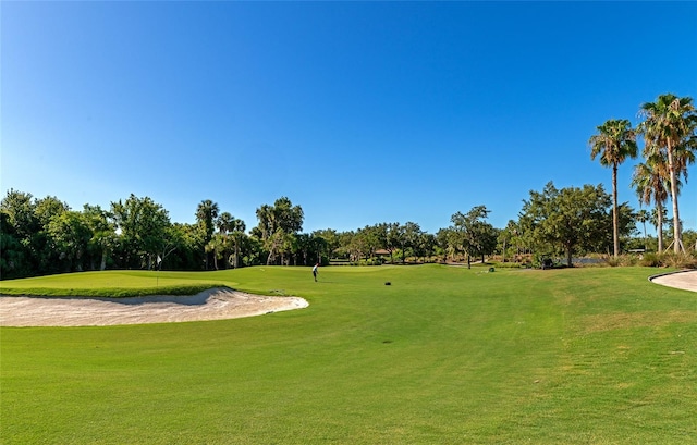 view of home's community featuring a yard and golf course view