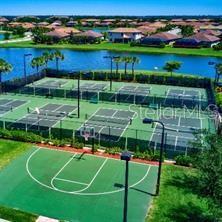 view of basketball court with community basketball court, a water view, and fence