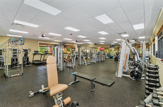 workout area featuring ceiling fan, a drop ceiling, and visible vents