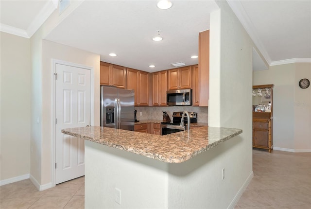 kitchen with appliances with stainless steel finishes, ornamental molding, and light stone counters