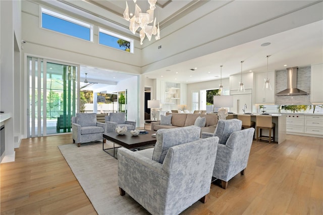 5103 Windward Ave, Sarasota, FL 34242 - living room with a chandelier, light wood finished floors, and a towering ceiling