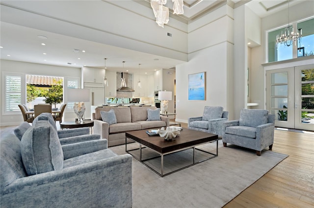 5103 Windward Ave, Sarasota, FL 34242 - living area with a chandelier, light wood-style floors, recessed lighting, and a towering ceiling