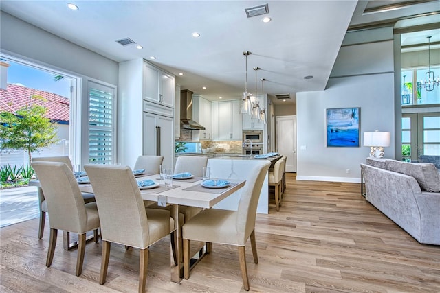 5103 Windward Ave, Sarasota, FL 34242 - dining space with light wood-style flooring, plenty of natural light, recessed lighting, and a chandelier