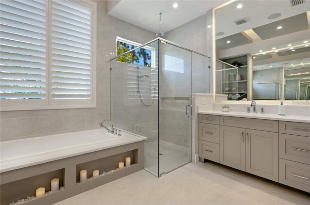 5103 Windward Ave, Sarasota, FL 34242 - bathroom featuring a shower stall, a garden tub, vanity, tile patterned flooring, and recessed lighting