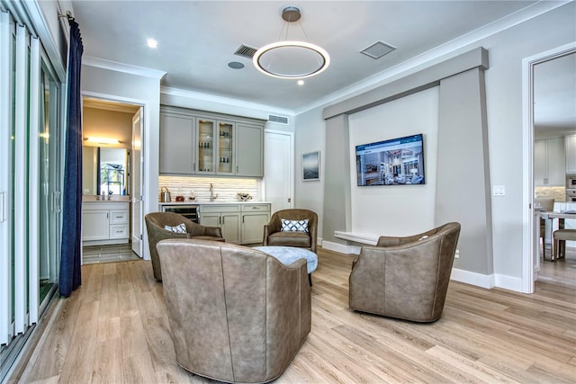 5103 Windward Ave, Sarasota, FL 34242 - living area featuring crown molding, light wood-style floors, recessed lighting, and bar