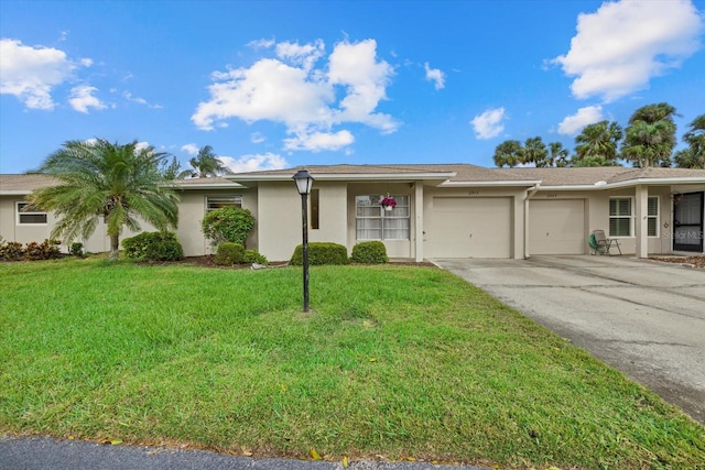 single story home featuring a garage, concrete driveway, a front yard, and stucco siding