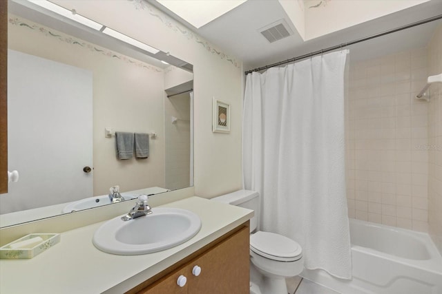 bathroom featuring toilet, vanity, visible vents, tile patterned floors, and shower / tub combo with curtain