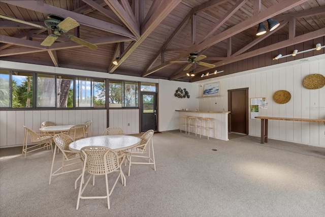 unfurnished sunroom with lofted ceiling with beams, wood ceiling, a dry bar, and ceiling fan