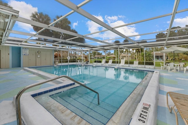 community pool featuring a patio and glass enclosure