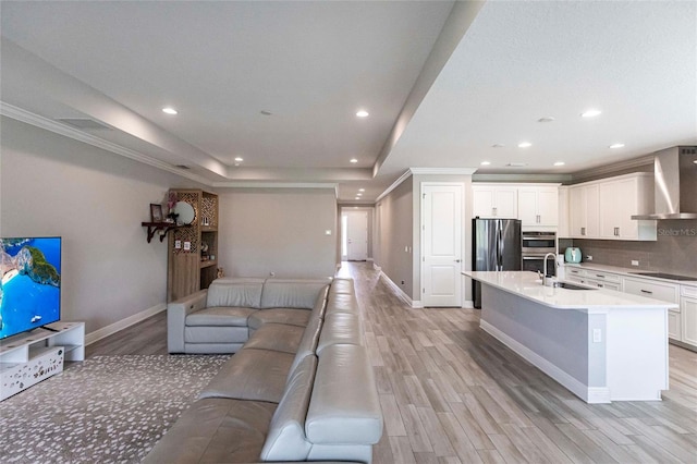 living area with baseboards, recessed lighting, and light wood-style floors