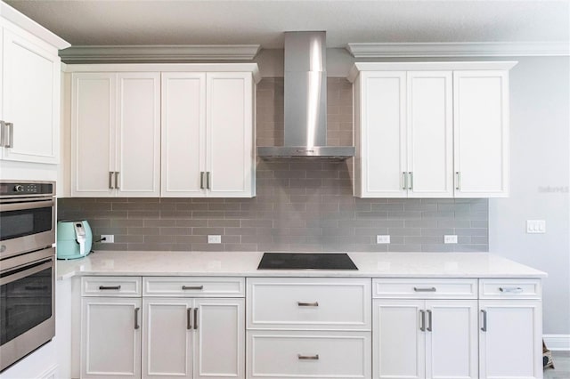 kitchen featuring wall chimney exhaust hood, black electric stovetop, double oven, and white cabinets